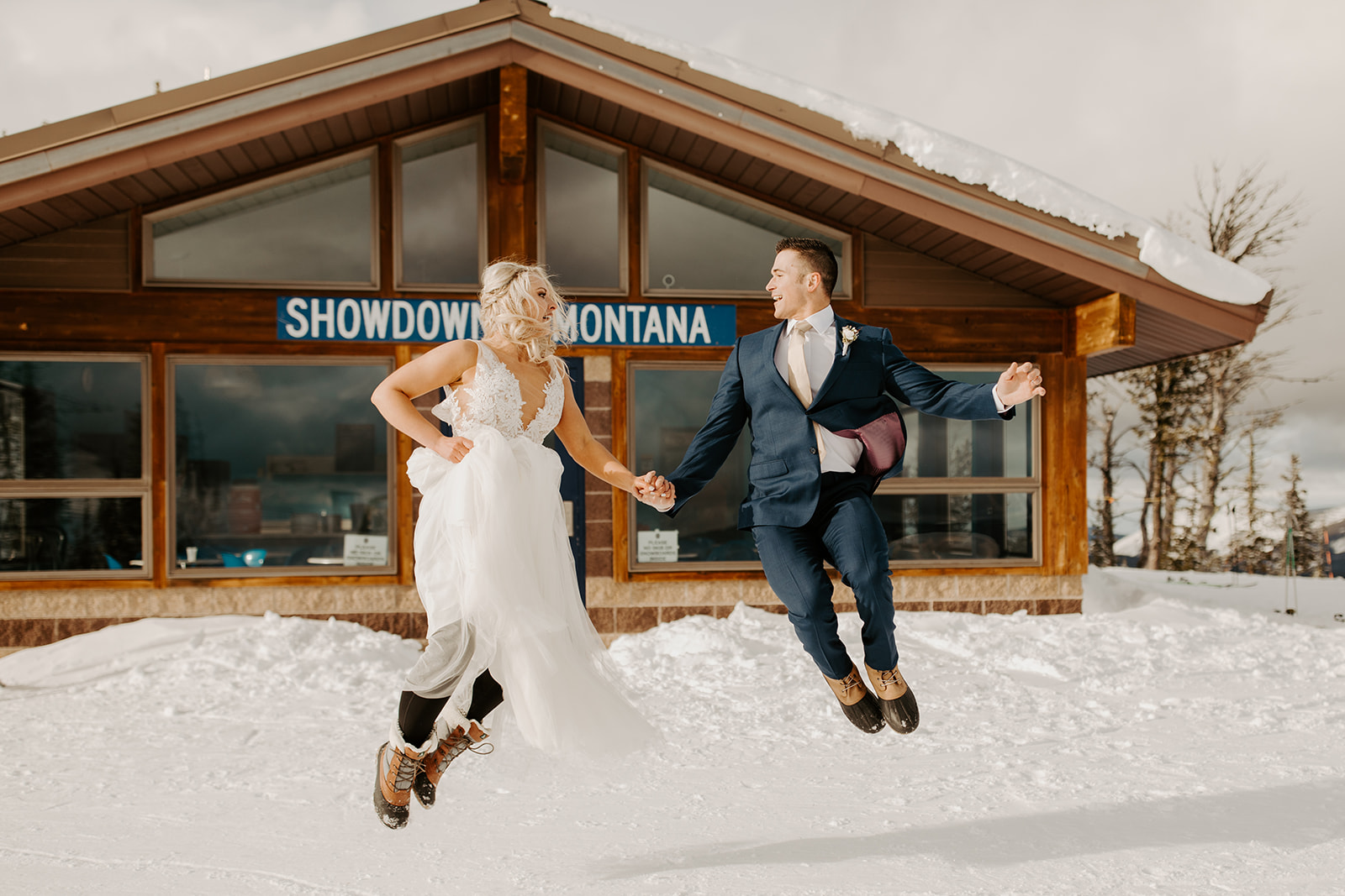 Adylee and Tyler jumping joyfully during their elopement at Showdown in Central Montana.